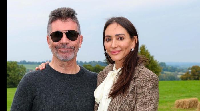 Simon Cowell wraps arm around fiancée Lauren during romantic getaway