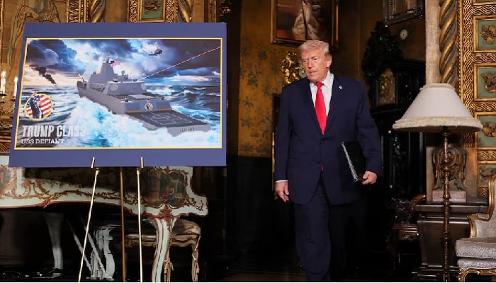 US President Donald Trump walks past a rendering of the Trump Class USS Deifant, at Mar-a-lago in Palm Beach, Florida, US, December 22, 2025. — Reuters