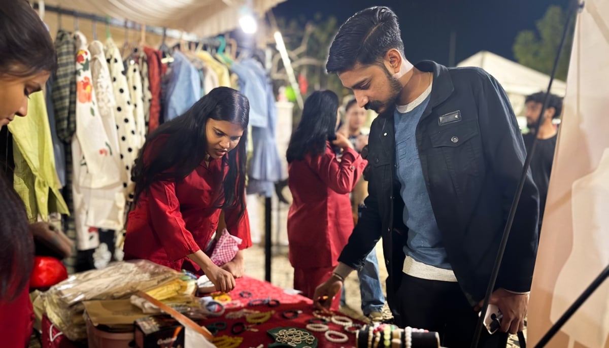 A customer looks at jewellery pieces at the stall set up by the young women of the church shelter. — Photo by author