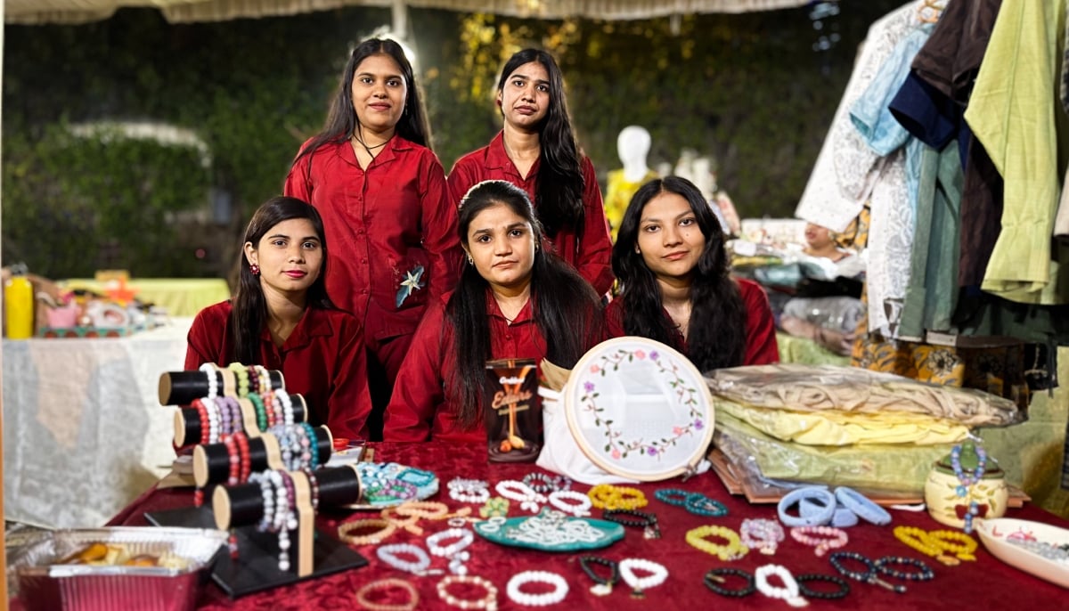A group of Christian young women pose for a photograph at their stall set up at the Alliance Française de Karachi. — Photo by author