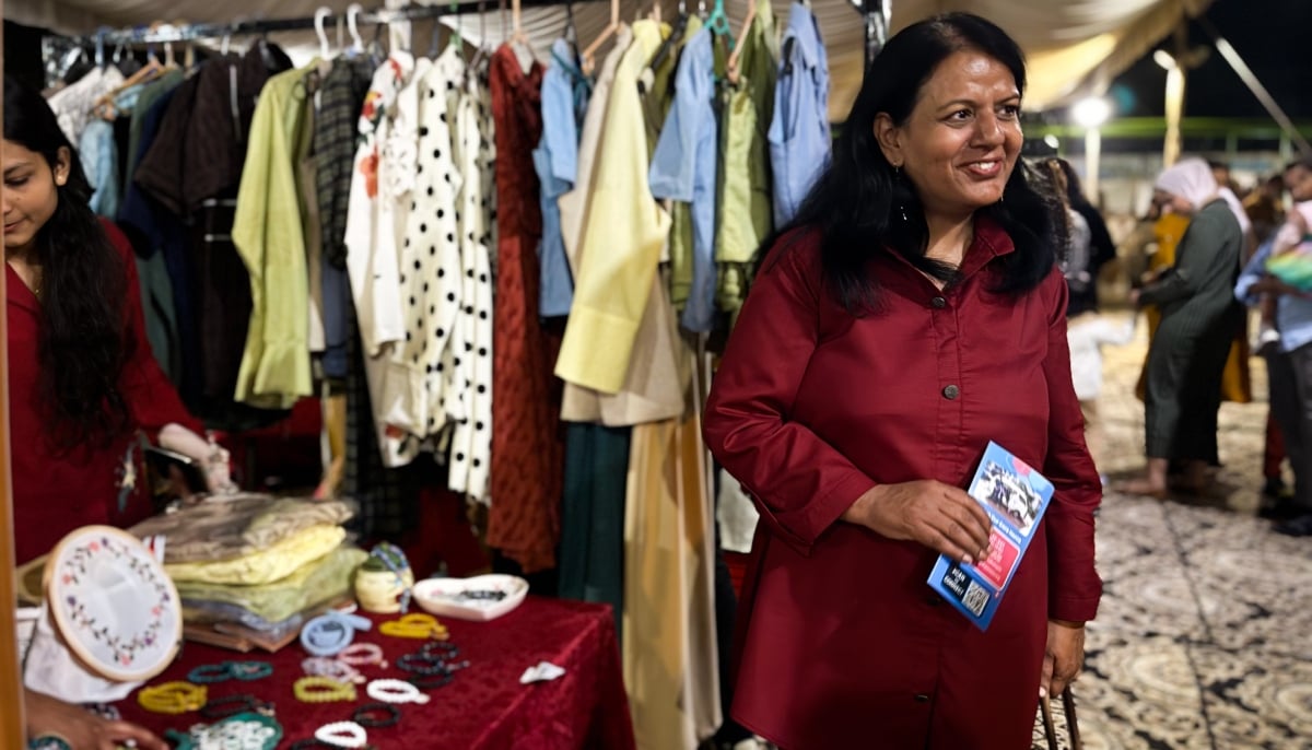 Pastor Ghazala Shafique stands next to the stall by the young women from her shelter. — Photo by author