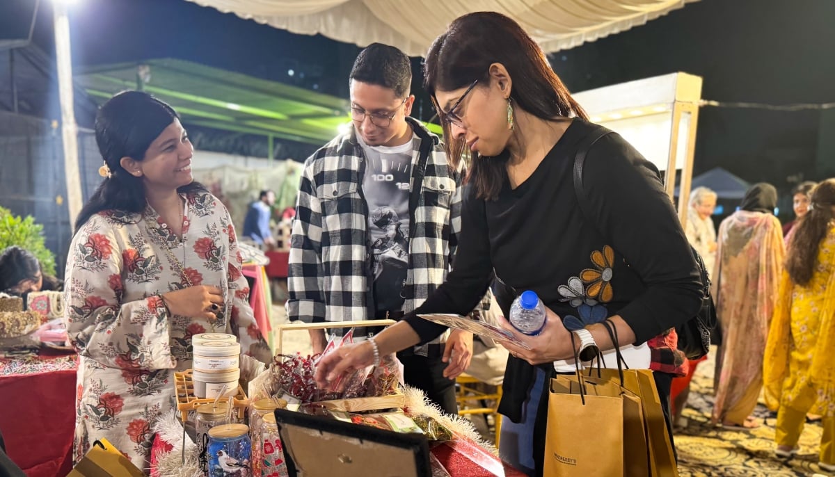Customers choose from decor items at Wendy Lobos stall at the Alliance Française de Karachi. — Reporter