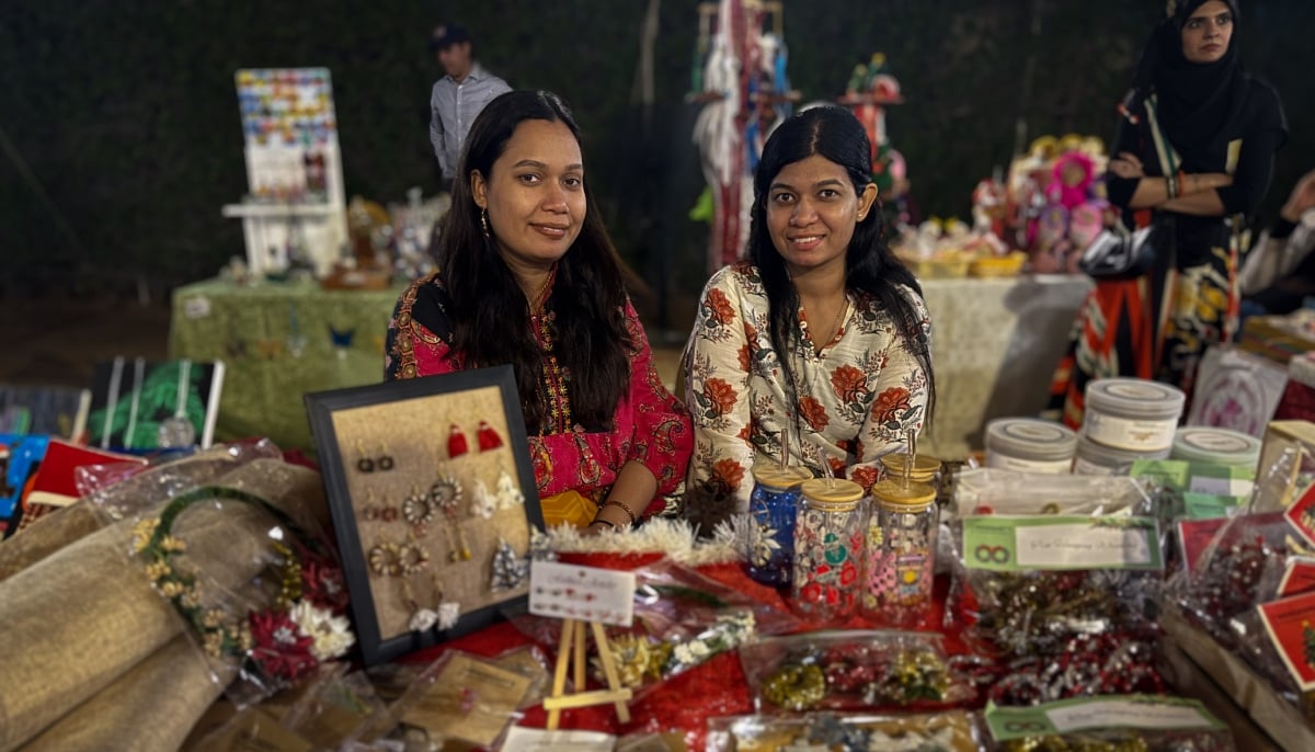 Wendy Lobo (left) poses for a photograph with her sister Audrey Lobo before their stall at the Alliance Française de Karachi. — Reporter