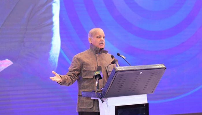 Prime Minister Shehbaz Sharif addresses the ceremony of distribution of laptops among students in University of Azad Jammu and Kashmir on December 24, 2025. — PID