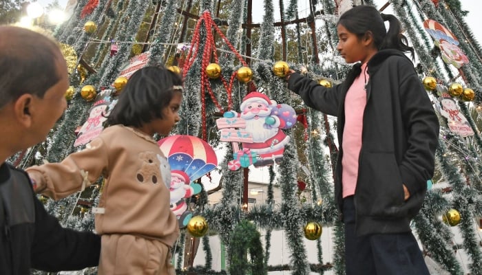 Member of Christian community decorate a Christmas tree during Christmas celebrations in Karachi, December 24, 2025. —  ONLINE