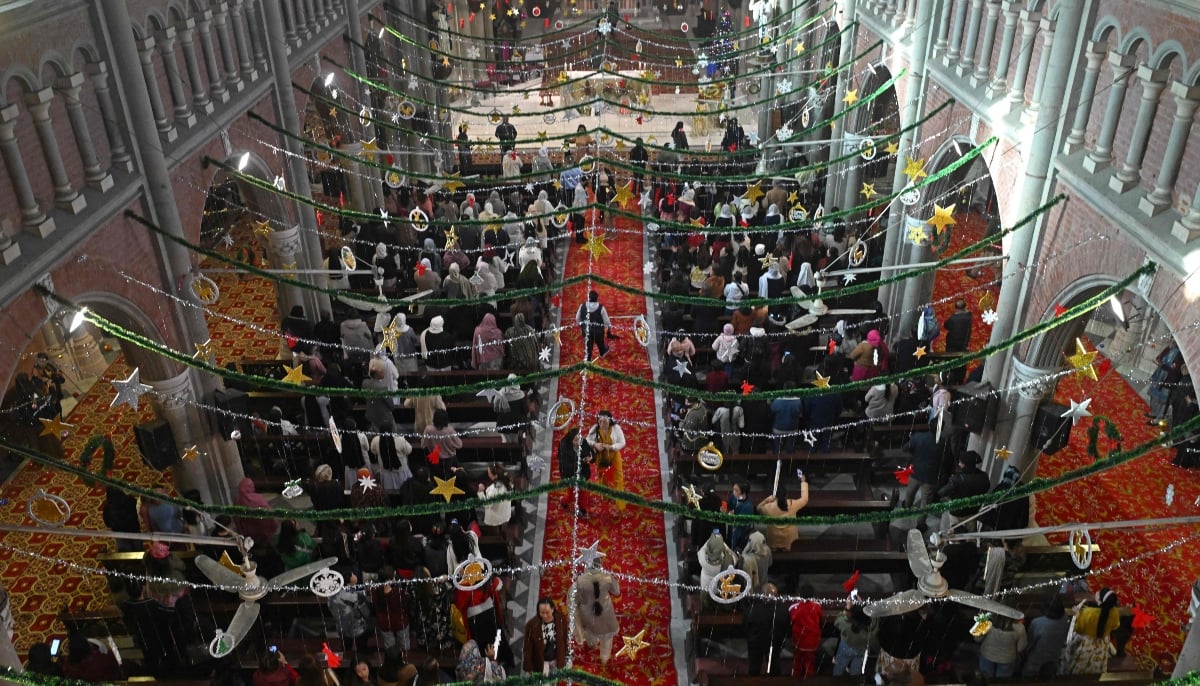 Christians pray during Christmas mass at Sacred Heart Cathedral in Lahore on December 25, 2025.  — AFP