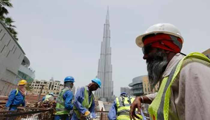 Labourers work near the Burj Khalifa, the tallest tower in the world, in Dubai in this May 9, 2013. — Reuters