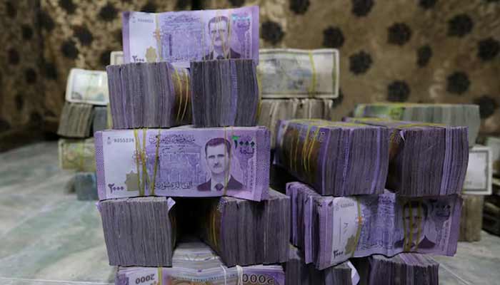 Stacks of Syrian pounds are pictured inside an exchange currency shop in Azaz, Syria.— Reuters/File