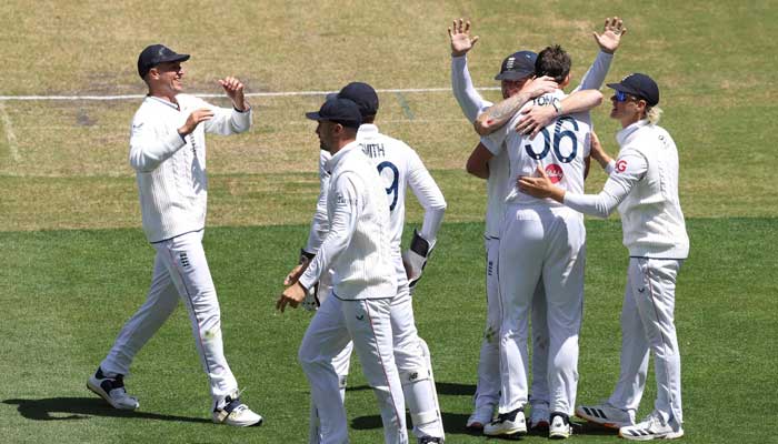 Englands players celebrate the wicket of Australia´s Scott Boland during the first day of the fourth Ashes cricket Test match between Australia and England at the MCG in Melbourne on December 26, 2025. — AFP