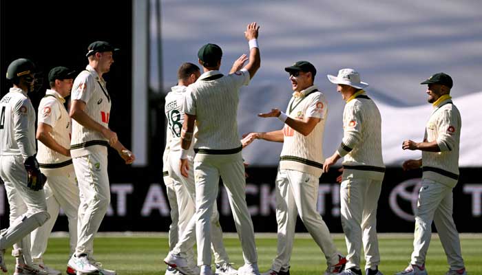 Australian players celebrate after dismiss England batsman Brydon Carse on the first day of the fourth Ashes Test at the Melbourne Cricket Ground (MCG) in Melbourne on December 26, 2025. — AFP
