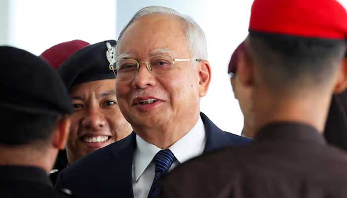 Prison officers escort former Malaysian PM Najib Razak, as the jailed politician leaves the court during a break in proceedings, in Kuala Lumpur, Malaysia. — Reuters/File