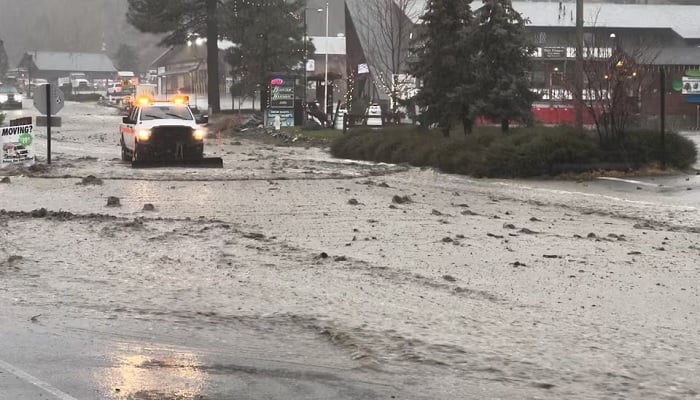 A vehicle moves through a flooded street during torrential rains, in San Bernardino County, California, U,S December 24, 2025, in this screengrab obtained from a social media video.— Reuters