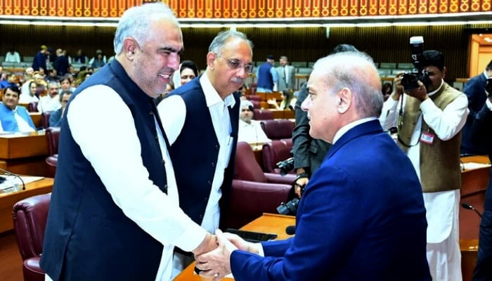 Prime Minister Shehbaz Sharif shakes hands with former speaker of the National Assembly and PTI leader Asad Qaiser (left), during a session of the National Assembly in Islamabad on June 26, 2024. —PMO