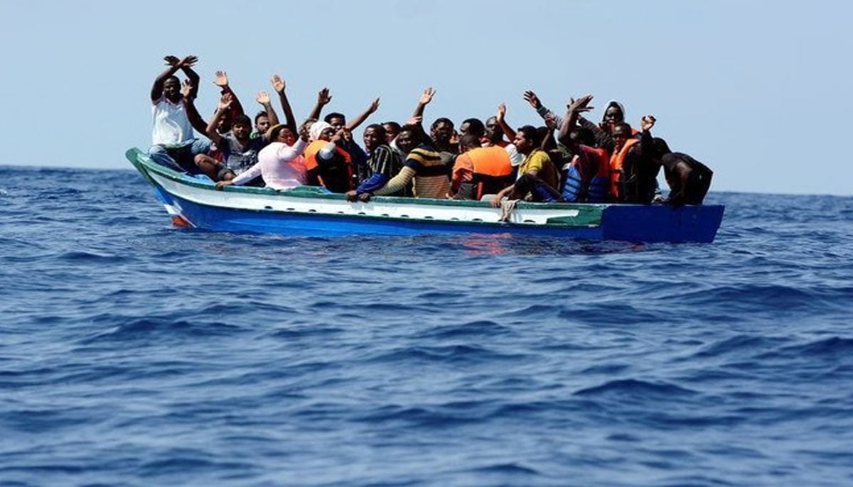 Migrants on a wooden boat react as they wait to be rescued by SOS Mediterranee organisation and Doctors Without Borders during a search and rescue (SAR) operation with the MV Aquarius rescue ship in the Mediterranean Sea, off the Libyan Coast, August 10, 2018. — Reuters
