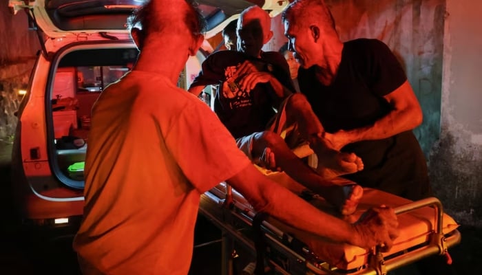 Local people rescue an elderly man during a fire at Werdha Damai retirement home in Manado, North Sulawesi Province, Indonesia, December 28, 2025. — Reuters