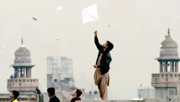 Pakistani youth enjoy flying kites during the Basant or kite flying festival in Lahore on February 6, 2005. — AFP