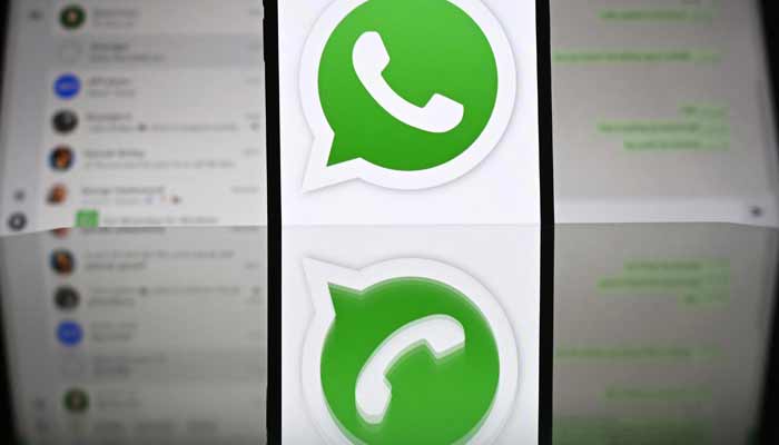 An illustration photograph taken on April 17, 2025, shows Whatsapp web displayed on a laptop screen with a phone displaying the Whatsapp logo. — AFP