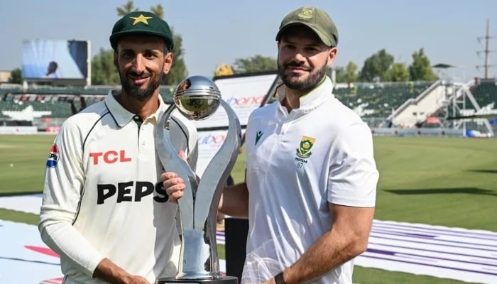 Skippers Shan Masood (left) and Aiden Markram pose with the shared trophy after the second Test between Pakistan and South Africa ended in a draw in Rawalpindi on October 23, 2025. — AFP