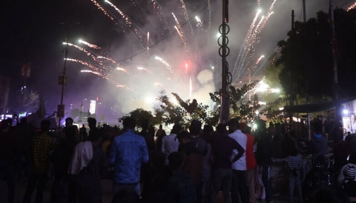 People watch a fireworks show during New Year celebrations in Karachi on early January 1, 2023. — AFP