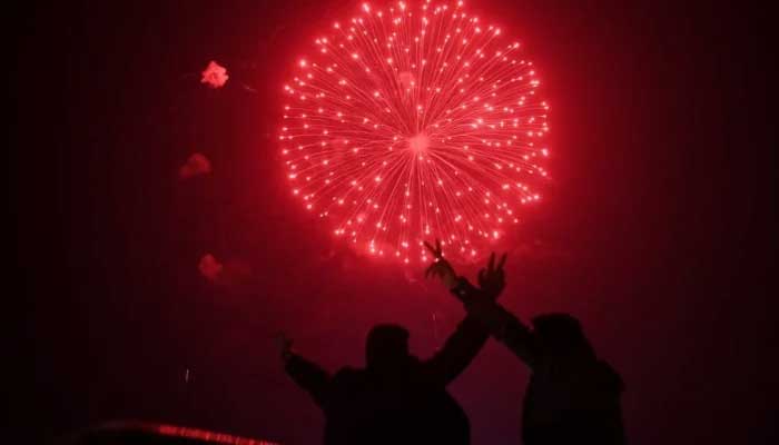 People watch fireworks light up the sky as New Year celebrations begin in Karachi. — AFP/File