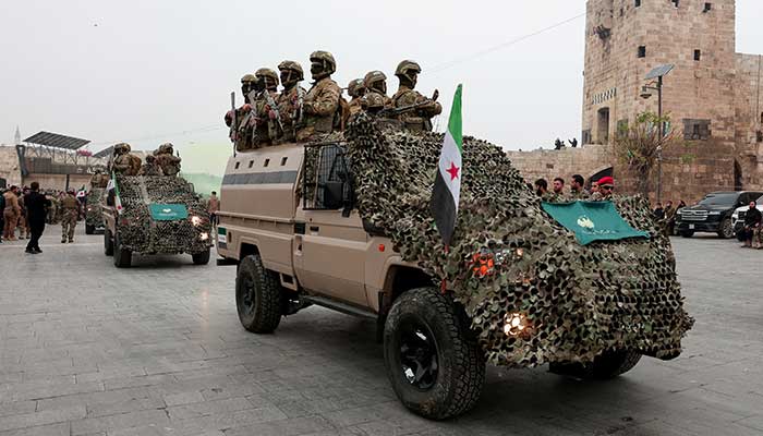 Syrian army members take part in a military parade, as they mark the first anniversary of Bashar al-Assads fall, in Aleppo, Syria December 8, 2025. — Reuters