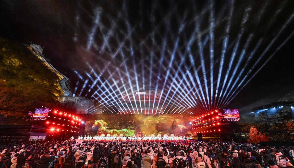 Dancers perform on stage as people celebrate the New Year 2026 at the Juyongguan Great Wall, Beijing, on January 1, 2026. — AFP
