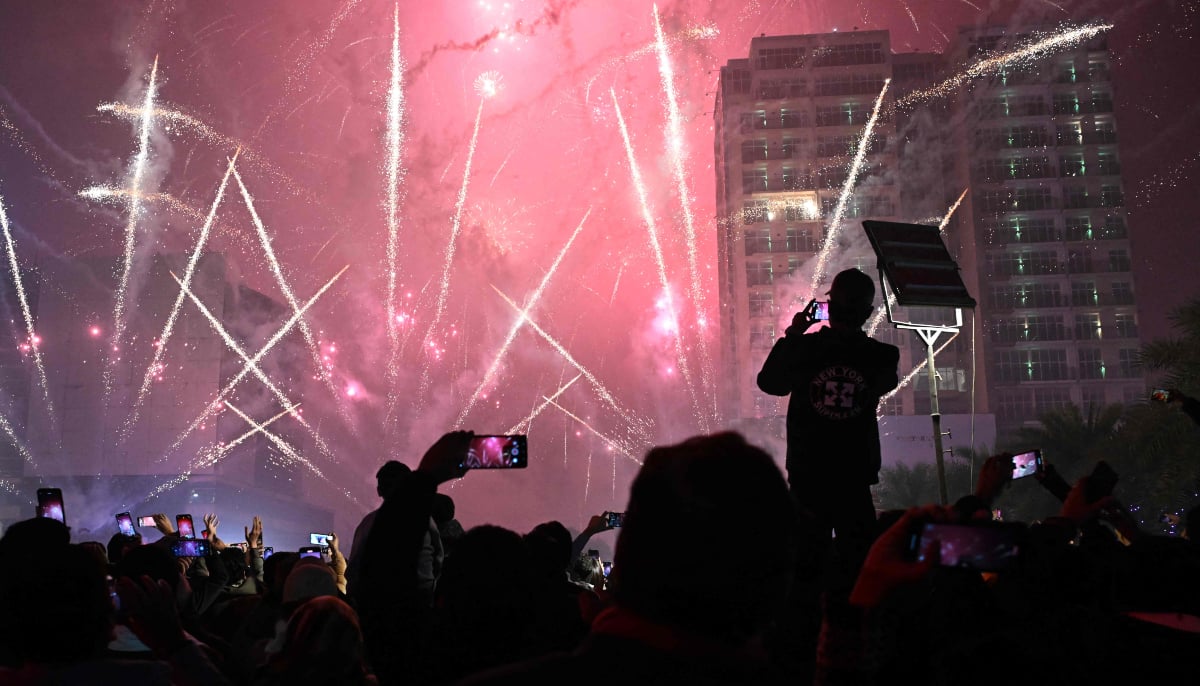 Revellers watch fireworks during the New Year celebrations in Lahore on January 1, 2026. — AFP