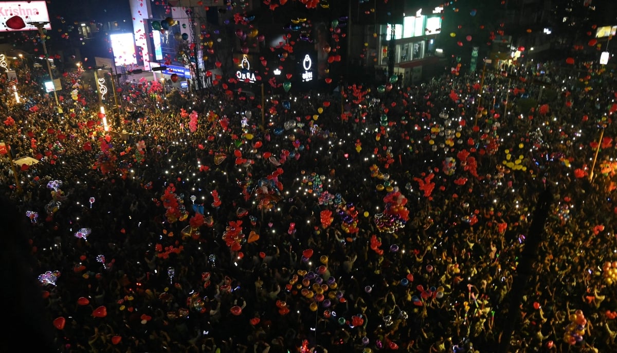 Revellers celebrate the New Year at CG road in Ahmedabad on January 1, 2026. — AFP