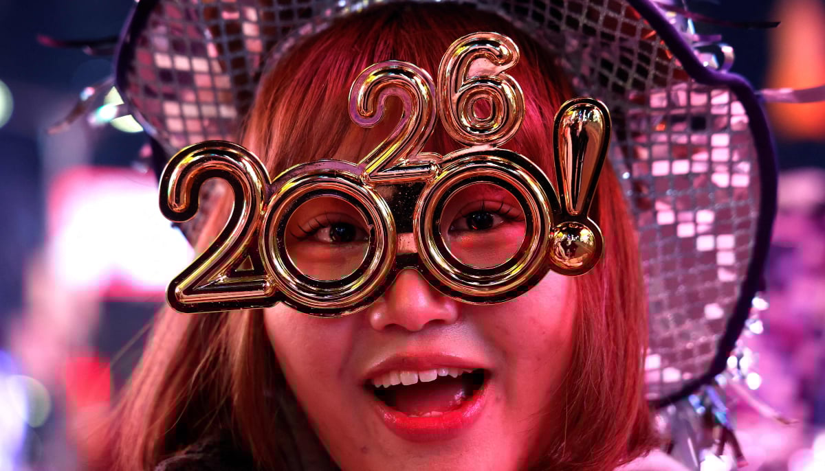 A reveler poses as she celebrates New Year´s Eve in Times Square on December 31, 2025 in New York. — AFP