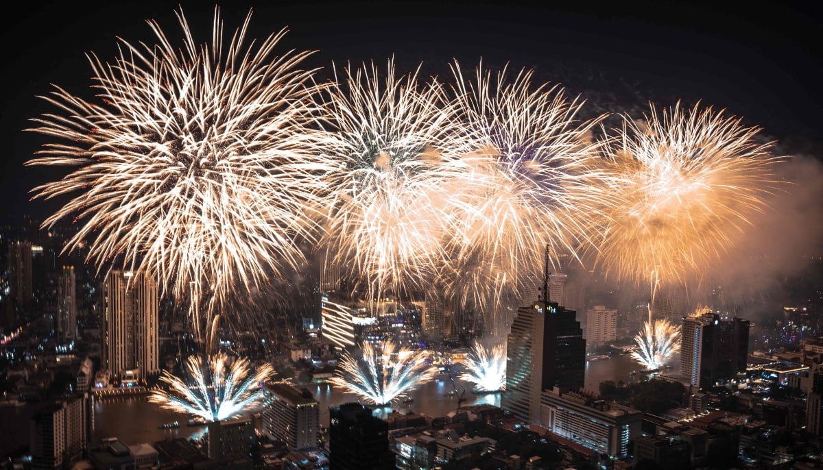 Fireworks light up the midnight sky over the Chao Phraya River during 2026 New Year´s Day celebrations in Bangkok on January 1, 2026. — AFP