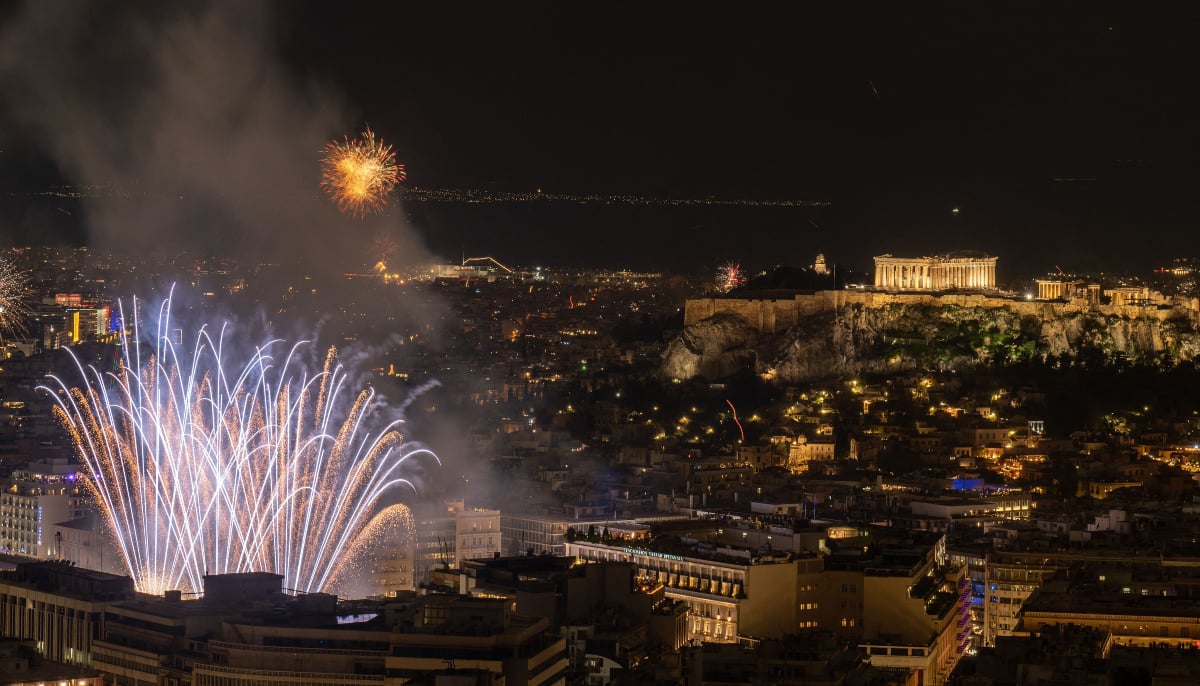 Fireworks explode next to the ancient Parthenon temple atop the Acropolis during New Year celebrations in Athens, early on January 1, 2026. — AFP