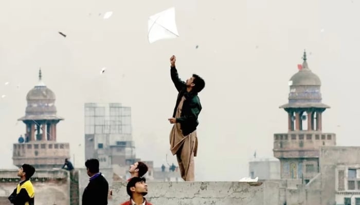 Pakistani youth enjoy flying kites during the Basant or kite flying festival in Lahore on February 6, 2005. — AFP