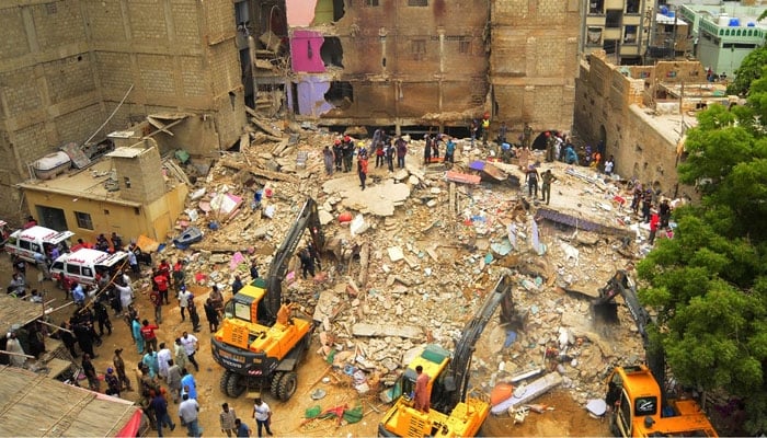 Rescue workers search for victims under the rubble after a five-story residential building collapsed in Karachi on July 04, 2025. — INP