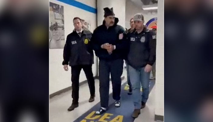A still image shows Venezuelas President Nicolas Maduro being walked in custody down a hallway at the offices of the US Drug Enforcement Administration (DEA) in New York City, US, January 3, 2026. — Reuters
