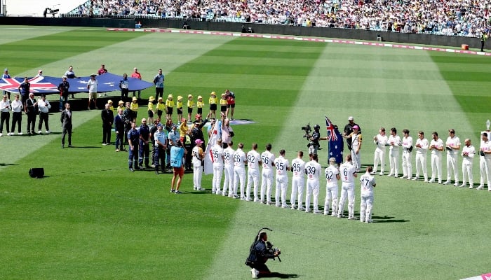 Emergency service personnel and members of the public (C) who responded during a mass shooting at Bondi Beach acknowledge the crowd after receiving a guard of honour on day one of the fifth Ashes cricket Test match between Australia and England at the Sydney Cricket Ground (SCG) in Sydney on January 4, 2026. — AFP
