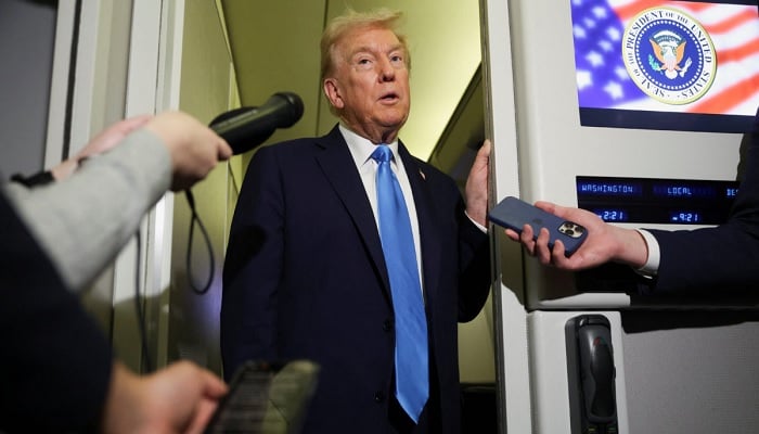 US President Donald Trump talks to reporters on board Air Force One. — Reuters/File
