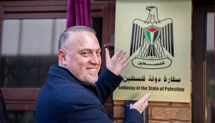Palestinian Ambassador to the UK Husam Zomlot gestures towards the plaque during the official inauguration of the Embassy of the State of Palestine in London on January 5, 2026. — X/@hzomlot