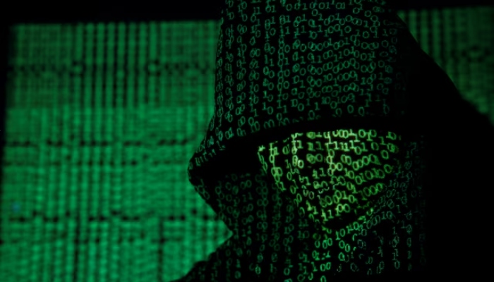 A projection of cyber code on a hooded man is pictured in this illustration picture taken on May 13, 2017. — Reuters