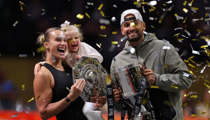 Belarus Aryna Sabalenka, her goddaughter Nicole, and Australias Nick Kyrgios celebrate with trophies after the Battle of the Sexes match in Dubai on December 28, 2025. — Reuters