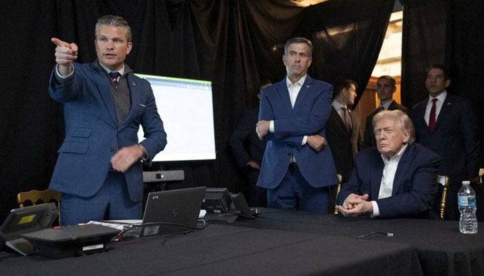 A photograph posted by US President Donald Trump on his Truth Social account shows him sitting near CIA Director John Ratcliffe and US Secretary of Defense Pete Hegseth as they watch the US military operation in Venezuela on January 3, 2026.