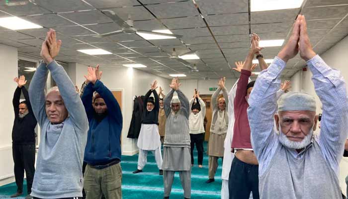 Old men exercise in the mosque of Bradford. — BBC