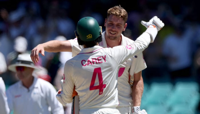 Australias  Cameron Green (right) and teammate Alex Carey celebrate after hitting the winning runs on day five of the fifth Ashes cricket Test match between Australia and England at the SCG in Sydney on January 8, 2026. — AFP