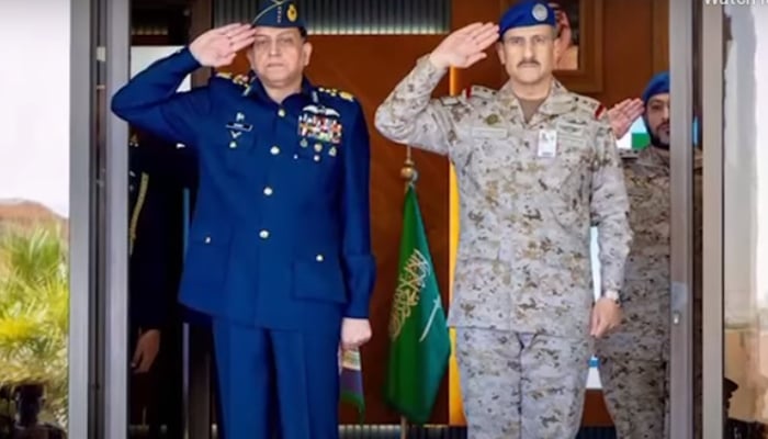 Chief of Air Staff Air Chief Marshal Zaheer Ahmed Baber Sidhu (left) and Commander of the Royal Saudi Air Force Lieutenant General Turki bin Bander bin Abdulaziz salute during a photo session. — ISPR