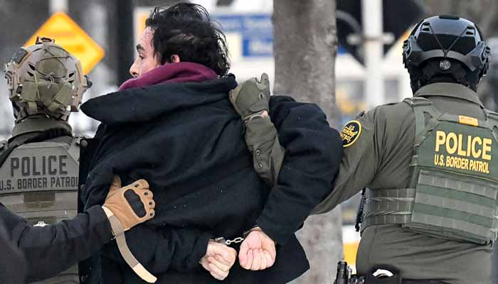 Federal agents detain a man as protestors demonstrate outside the Bishop Henry Whipple Federal Building in Saint Paul, Minnesota, January 8, 2026. — AFP