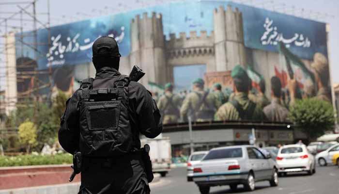 An Iranian security guard stands on a street, in Tehran, on June 24, 2025. — Reuters