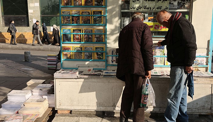 Iranian men read newspapers on a street, as protests erupt over the collapse of the currencys value, in Tehran, Iran, January 5, 2026. — Reuters