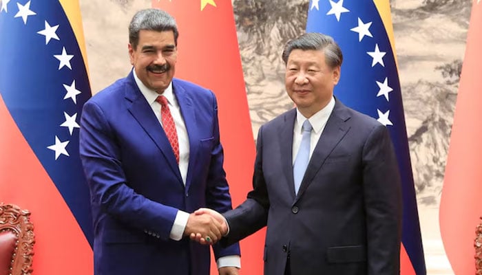 Venezuelas President Nicolas Maduro shakes hands with Chinas President Xi Jinping, during a meeting at the Great Hall of the People, in Beijing, China. — Reuters/File