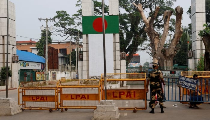 A Border Security Force (BSF) official stands in front of the gates of the India-Bangladesh international border in Petrapole, India, October 16, 2024. — Reuters