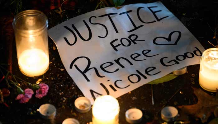 A sign reading Justice for Renee Nicole Good lays next to LED candles during a protest at the US Immigration and Customs Enforcement facility on January 9, 2026 in Portland.— AFP