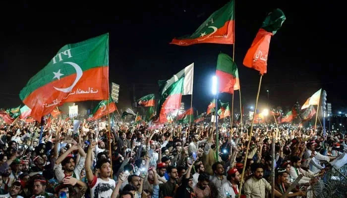 The Pakistan Tehreek-e-Insaf (PTI) flags can be seen at the rally in this image. — AFP/File